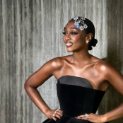 Musician Beverley Knight in black gown with hands on hips.